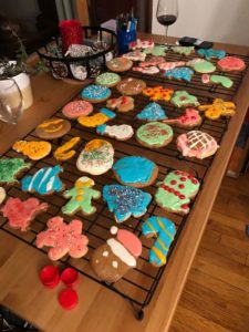 Frosted Christmas cookies in assorted shapes, on rack on top of table